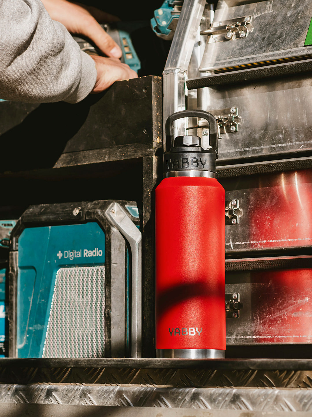 1.2L Yabby Red Insulated Stainless Steel Bottle with Swig Lid. Triple Wall. Outdoors on Tradie work site Australia. Best Red drink bottle.