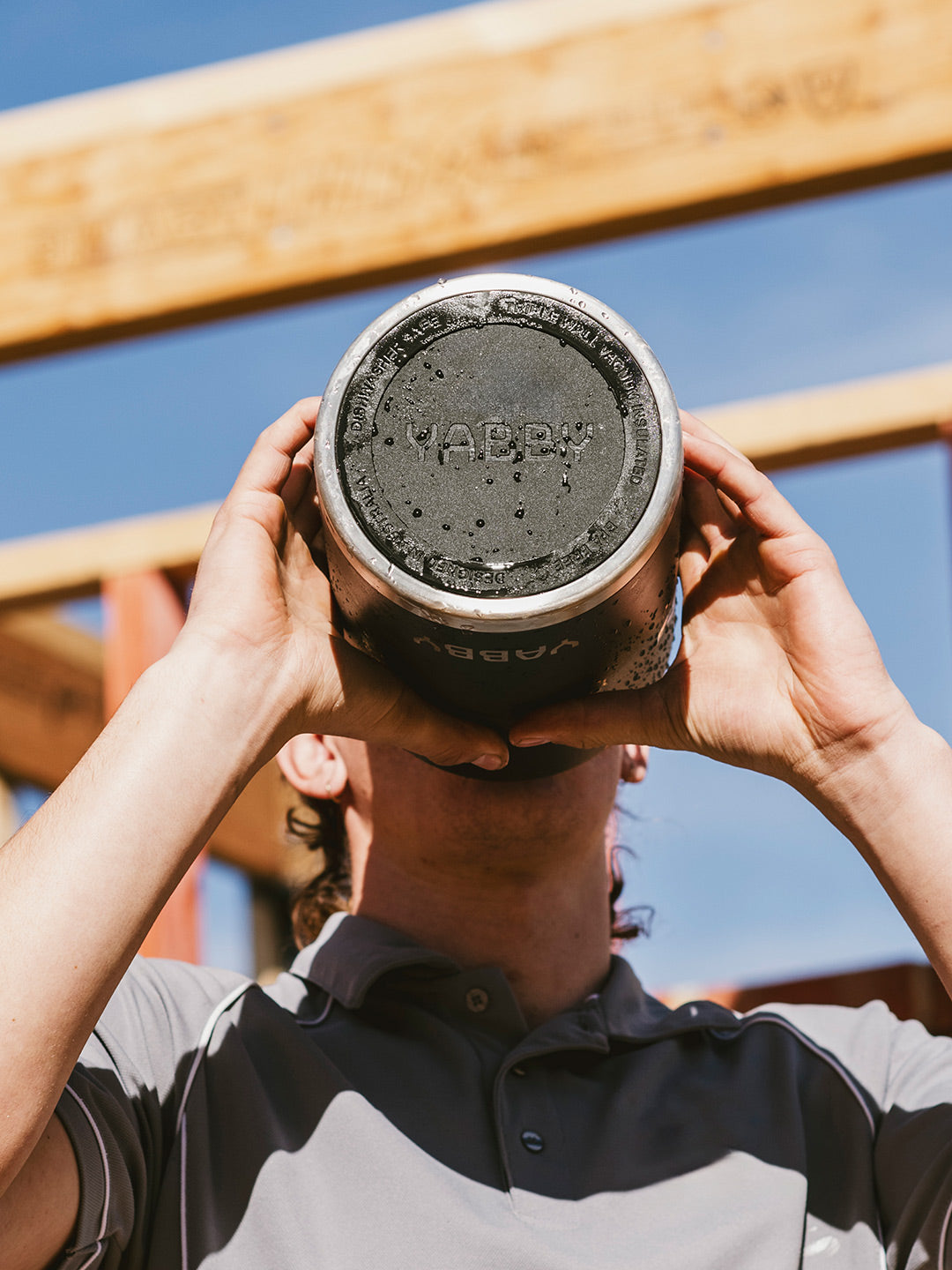 Man drinking ice cold water from Black Water Jug by Yabby Outdoors. Best Stainless Steel with Triple Wall Insulation.