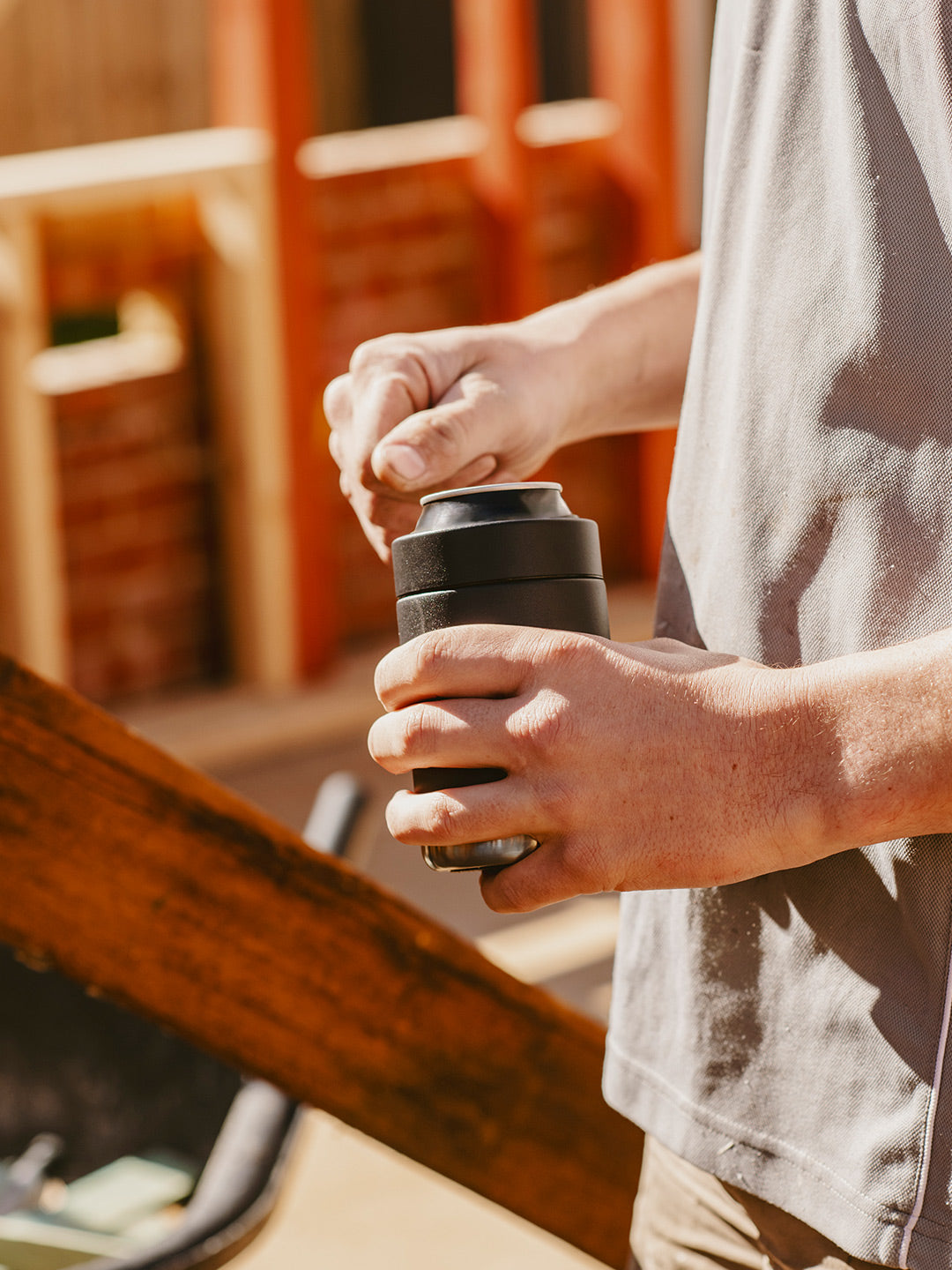 Man holding Stubby Holder and Can Cooler with beverage, made from Insulated Stainless Steel to keep it cold for longer. By Yabby Outdoors.