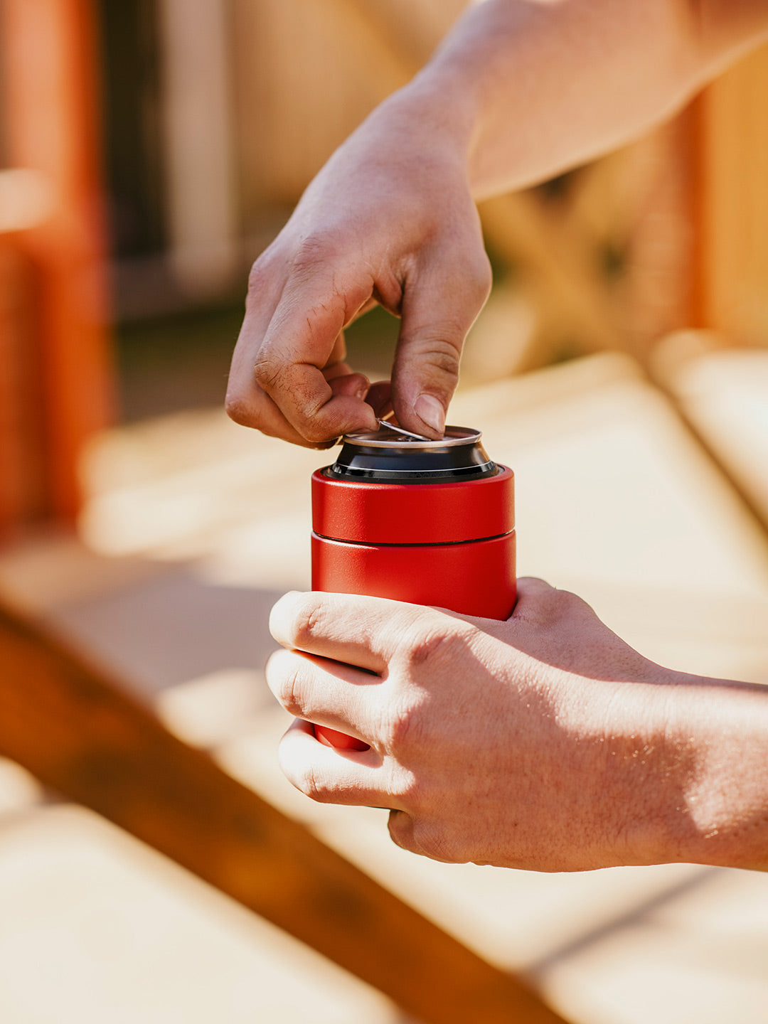 Crack opening a Can of Drink in an Insulated Stubby Holder & Can Cooler that keeps drinks icy cold. Red Can Cooler By Yabby Outdoors Australia.