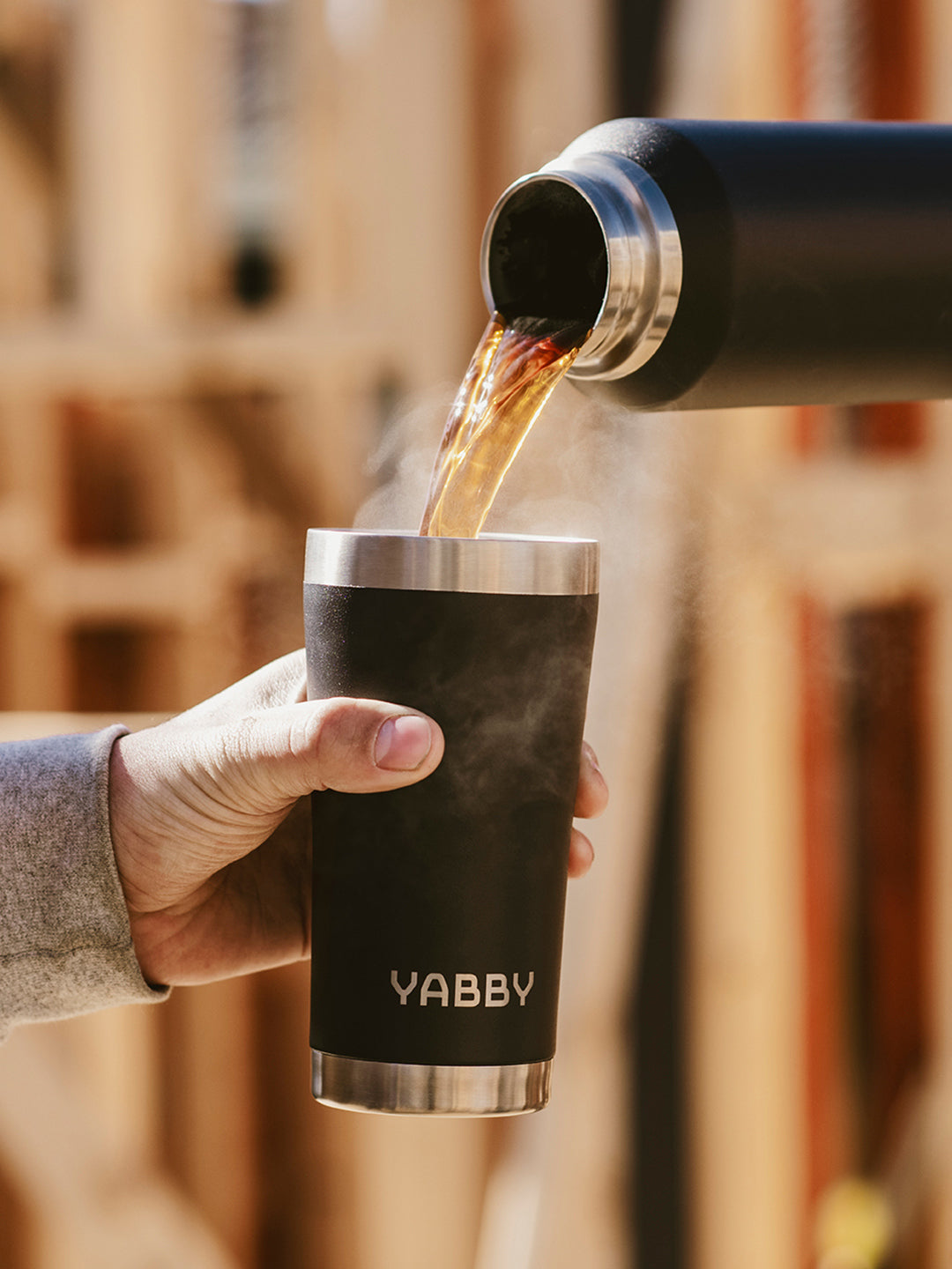 Pouring coffee into the Best Coffee Tumbler in Australia. Insulated Stainless Steel in Black with Triple wall to keep drinks hot and cold for longer. By Yabby Outdoors.