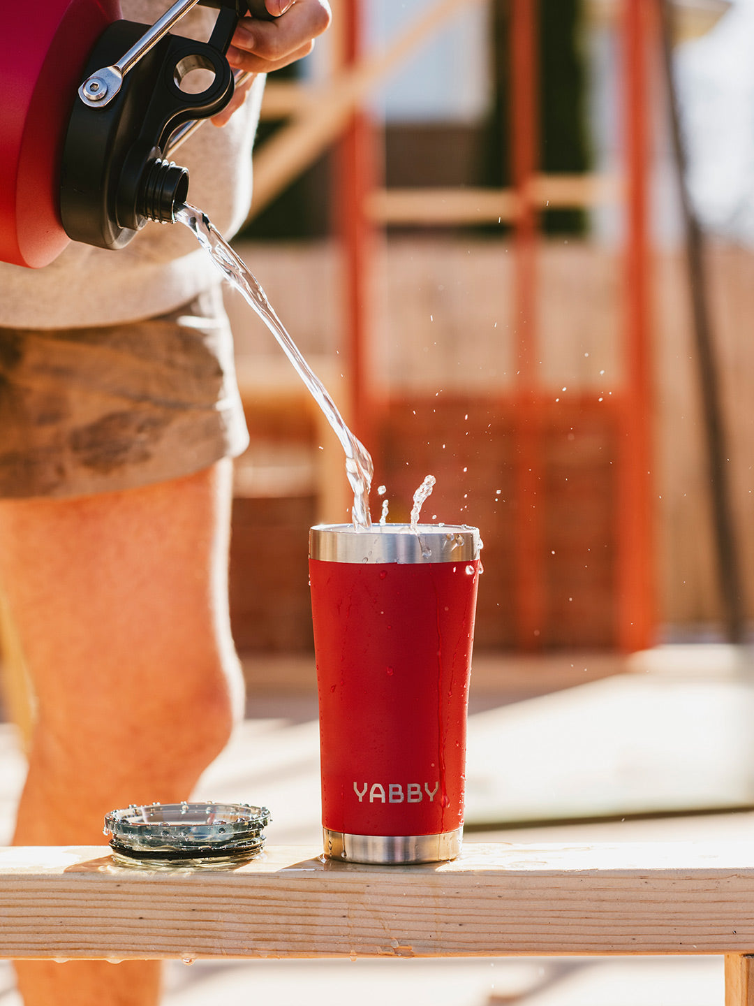 Pouring coffee into the Best Red Coffee Tumbler in Australia. Insulated Stainless Steel in colour Red with Triple wall to keep drinks hot and cold for longer. By Yabby Outdoors.